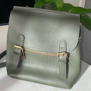 Dark green faux leather multi-pocket backpack.